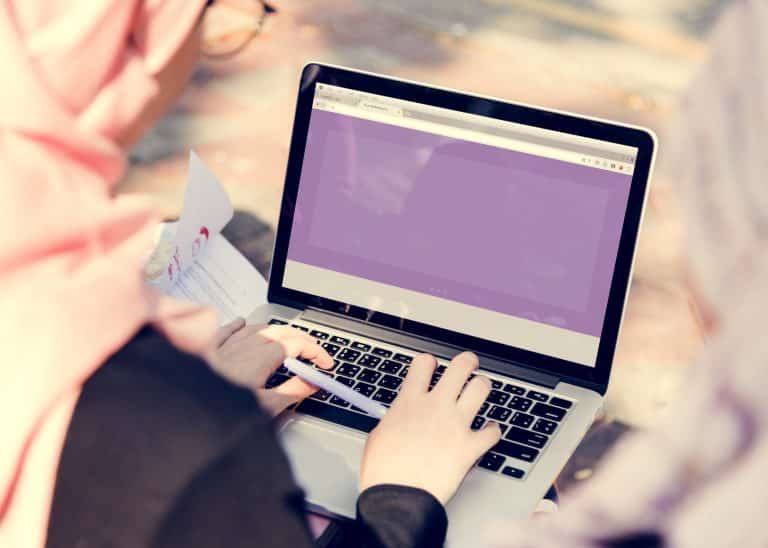 Islamic women searching on laptop