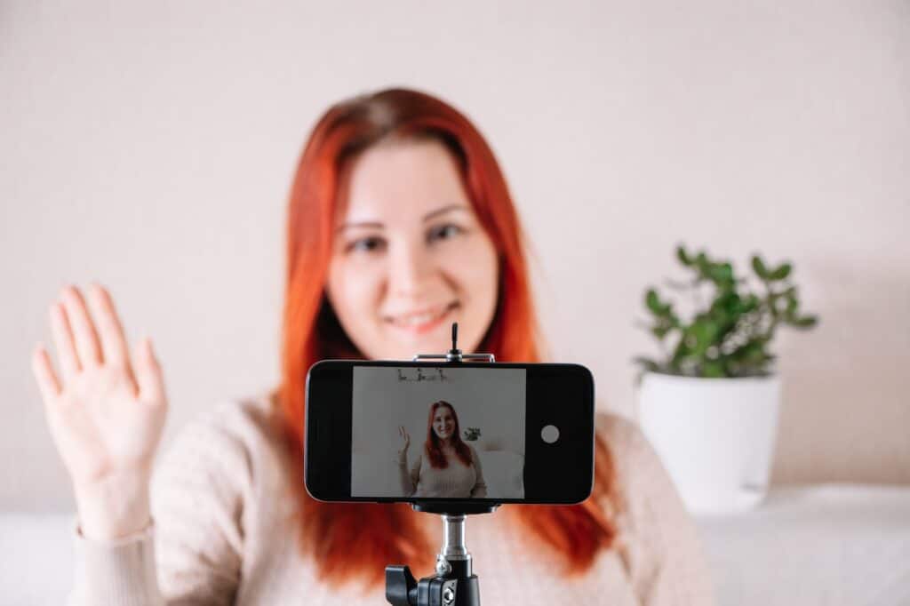 Young woman blogger influencer is recording video for her vlog.
