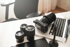 Workplace with a modern equipment for photography. Mirrorless camera and prime lenses.