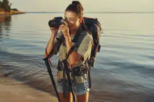 Female photographer taking a picture on coastline