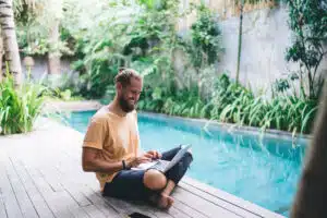 Happy travel blogger creating content text using laptop technology for messaging